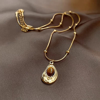 Collar de Ámbar y Ojo de Tigre: Energía, Elegancia y Protección en Tu Estilo
