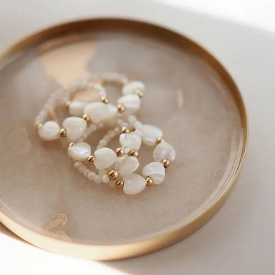 Trío de anillos de rodocrosita y perlas